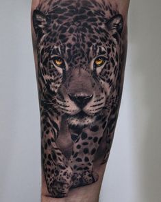 a man's leg with a black and white tattoo of a leopard on it