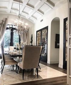 an elegant dining room with chandelier and marble flooring