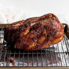 a large piece of meat sitting on top of a metal rack