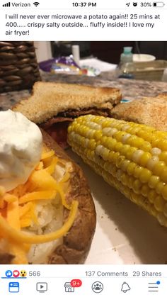 an image of corn on the cob with cheese and sour cream in between it