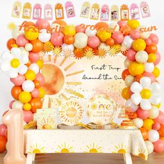 an orange, yellow and white birthday party with balloons