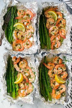 two foil packets filled with shrimp and asparagus