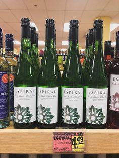 several bottles of wine are on display in a grocery store for $ 4 99 each