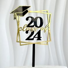 a graduation cake topper with the number twenty four