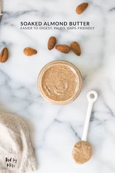 some almonds and peanut butter on a white marble counter top with the words soaked almond butter