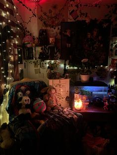 a room with lights and stuffed animals on the bed, in front of a window