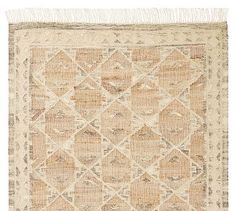 an old rug with fringes on the edges and a diamond pattern in beige tones