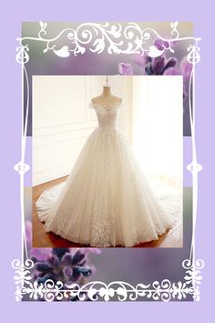 a wedding dress is displayed on a mannequin in front of purple and white flowers