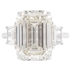 an emerald cut diamond ring with three baguets