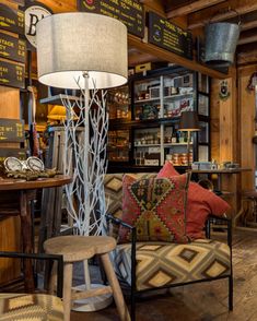 a room filled with lots of different types of furniture and decor on display in front of a store window