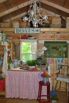 the inside of a log cabin with a chandelier hanging from it's ceiling