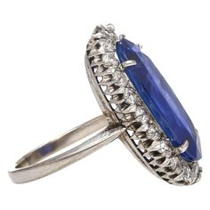 Shop this antique relic from a simpler time. An unheated 11.30-carat oval cut Blue Sapphire of Burmese origin. Set in platinum with a round-cut diamond halo. GRS certified with origin report. Circa late 1800's. The sapphire's natural inclusions, akin to distinctive birthmarks, give the stone a genuine authenticity and individuality, adding a unique personality and character.  This ring features a long oval cut that sits beautifully on the finger. Designed with an open back setting that maximizes Oval Sapphire Diamond Ring With Rose Cut Diamonds, Antique Oval Sapphire Diamond Ring, Victorian Sapphire Ring With Diamond Oval Shape, Antique Oval Sapphire Ring With Diamond Accents, Vintage Blue Oval Sapphire Ring, Victorian Oval Sapphire Ring With Diamond, Antique Blue Diamond Ring For Formal Occasions, Antique Blue Oval Diamond Ring, Antique Oval Sapphire Ring In Platinum