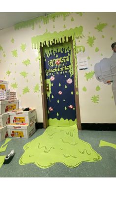 an office decorated in green and white with decorations on the walls, paper streamers flying around