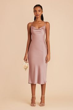 a woman wearing a pink slip dress