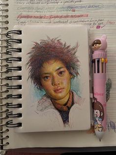 a notebook with a drawing of a young man