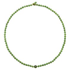 This is a brand new, handmade necklace created from very fine, highly translucent nephrite jade beads. Featuring a unique "button hole" clasp and a central focal-point bead, the nephrite from which this necklace was created is a step above the typical green nephrite seen in contemporary jewelry. The forrest-green color here is even throughout the 88 beads, each of them is highly translucent and the necklace simply radiates luminosity. The beads measure approximately 6mm and the large central bea Green Single Strand Pearl Necklace, Single Strand Green Pearl Necklace, Classic Green Gemstone Beads Necklace, Button Hole, Nephrite Jade, Jade Necklace, Jade Beads, Contemporary Jewelry, Handmade Necklace