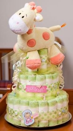 a giraffe diaper cake sitting on top of a table