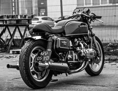 a black motorcycle parked in front of a building