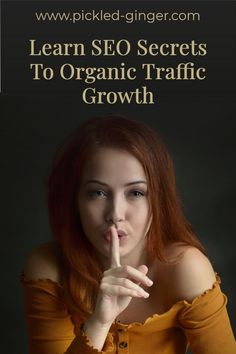 a woman with red hair is holding her finger up to her mouth and the words learn seo secrets to organic traffic growth