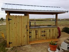 an outdoor kitchen made out of wood and metal