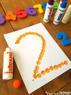 an art project for kids with letters and numbers on the table next to crayons