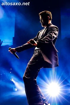 a man in a suit and tie on stage