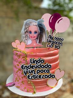 a birthday cake with a barbie doll on top