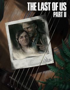 the last of us part ii poster with guitar and plant on wooden table next to it