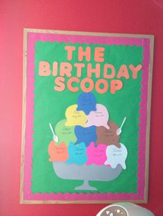 the birthday scoop poster is hanging on the wall