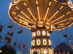 a merry go round at night with lights on