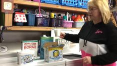 a woman standing in front of a washer and dryer