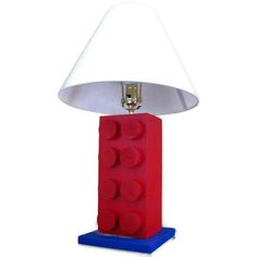 a lamp made out of legos with a red base and white lampshade