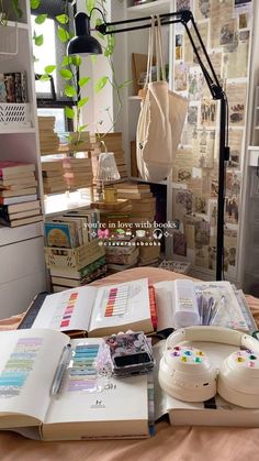 an open book sitting on top of a table next to a phone and other items