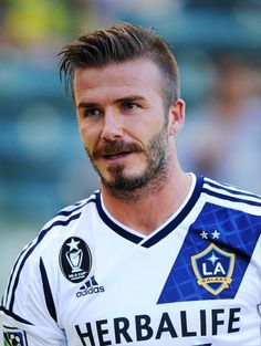 a close up of a soccer player with a goatee on his head and beard