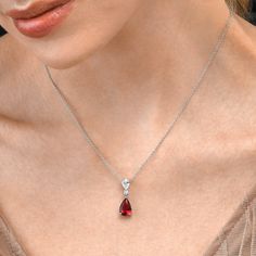 Features   * 925 Sterling Silver elegant drop pendant necklace for women with Red and White AAA cubic zirconia stones   * 25mm long drop pendant set with a 8mm x 12mm pear shaped ruby red cubic zirconia stone and a 5mm x 7mm pear shaped white cubic zirconia stone, pendant on an adjustable 18"    chain, including 2-inch extension links.   * Silver pendant necklace for women with red and white stones made in rhodium-plated 925 Sterling Silver   * All our sterling silver jewellery is Rhodium plated Silver Necklace With Red Stone, Ruby Silver Necklace, Red Silver Necklace, Silver Ruby Necklace, Elegant Red Necklace, Infinite Jewelry, Ruby Jewelry Set, Red Ruby Necklace, Ruby Necklace Designs