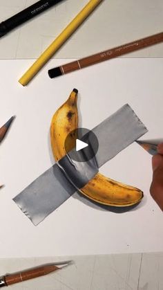 pencils and bananas are being used to draw the image with colored pencils on white paper