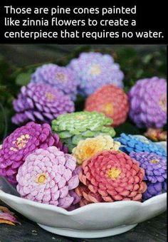 a white bowl filled with colorful flowers on top of a wooden table