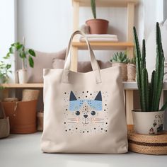 This farmers market-style canvas tote is a great for every day use or as a gift for someone special. You can use it for a trip to the market or for your day at the spa or Yoga studio.  We use a high quality professional direct to garment (DTG) process on our products, this means fabric-grade ink is printed directly onto the garment blending with the fibers. This process allows us to achieve a vintage style look on many of our designs, and a feel that is similar to screen-printing (which avoids t Beige Rectangular Bag With Cat Design, Daily Use Rectangular Canvas Bag With Cat Design, Travel Tote Canvas Bag With Cat Design, Casual Canvas Bag With Cat Design For Travel, Everyday Rectangular Bag With Cat Print, Cute Everyday Bags With Cat Design, Beige Cat Design Bag For Everyday Use, Beige Bag With Cat Design For Everyday Use, Everyday Beige Bag With Cat Design