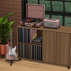 a room with a guitar, record player and other items