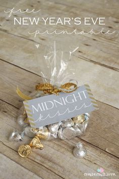 a small bag filled with gold and silver candies on top of a wooden table