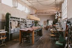 a room filled with lots of tables and chairs next to each other on top of hard wood flooring