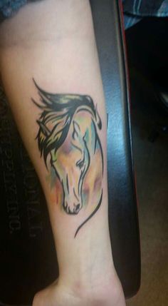 a horse tattoo on the foot of a person