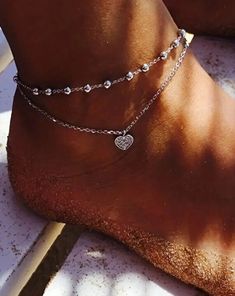 This stunning double heart anklet is the perfect accessory for any Boho babe! Crafted from high-quality, silver plated zinc alloy, this 8-inch anklet exudes a sense of effortless style. Featuring a playful heart, this anklet adds a touch of whimsy to any outfit. Whether you're running around town or lounging on the beach, this anklet will keep you looking chic and on-trend. So why wait? Add this piece to your jewelry collection today and show off your unique boho style! Check out other items in Heart Ankle Bracelet, Rhinestone Anklet, Star Anklet, Womens Ankle Bracelets, Anklet For Women, Boho Mode, Crystal Anklet, Leg Chain, Heart Anklet