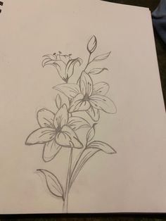 a drawing of some flowers on a piece of paper with a pencil in the middle