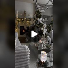 a christmas tree in the middle of a living room with white and silver decorations on it