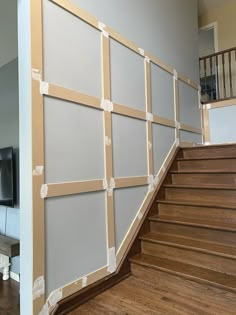 a stair case with some tape on it and a tv in the corner next to it