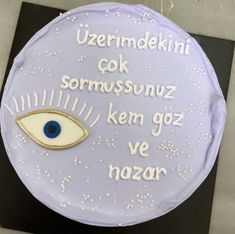 a cake decorated with words and an eye on it's side that says, uzerrimdniki cok sormussnuz kem goz ken goz ve nazar