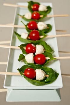 small appetizers with tomatoes and mozzarella on skewers are ready to be eaten