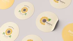 six cd's with yellow flowers on them sitting next to each other in front of a gray background