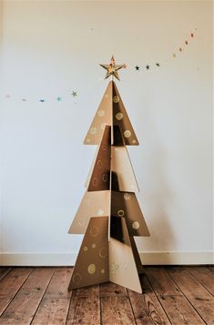 a cardboard christmas tree is on the floor